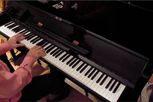 Dr. Weiss' hands playing the piano