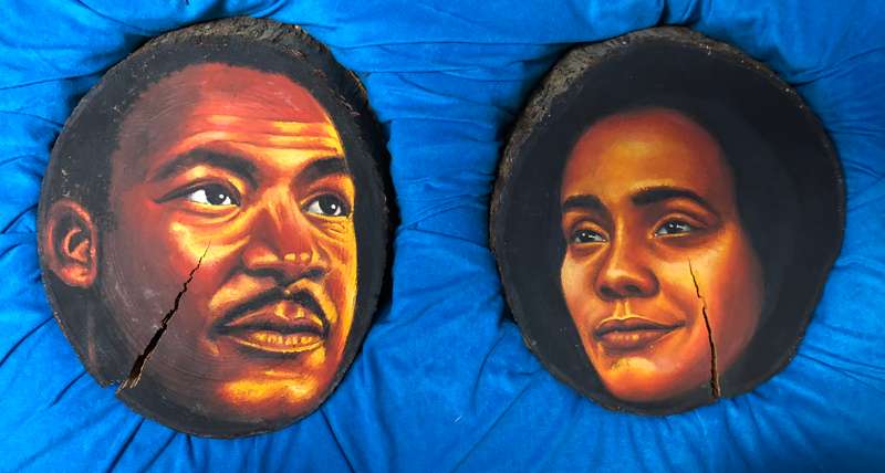Paintings of Martin Luther King Jr. and his wife Coretta done on cross-sections of tree