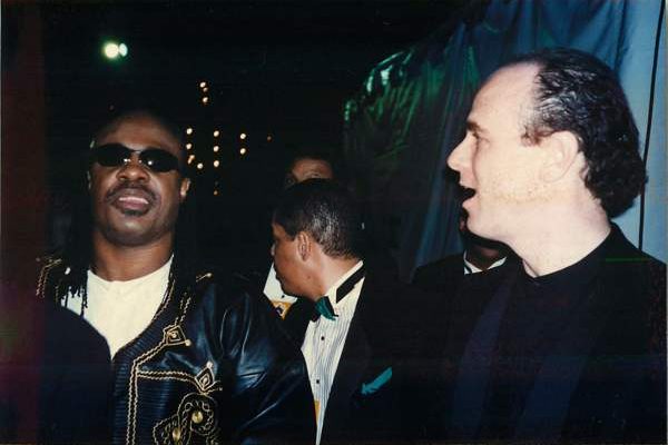 Stevie Wonder at the Grammys, with Dr. Weiss on the right hand side, looking excitedly.